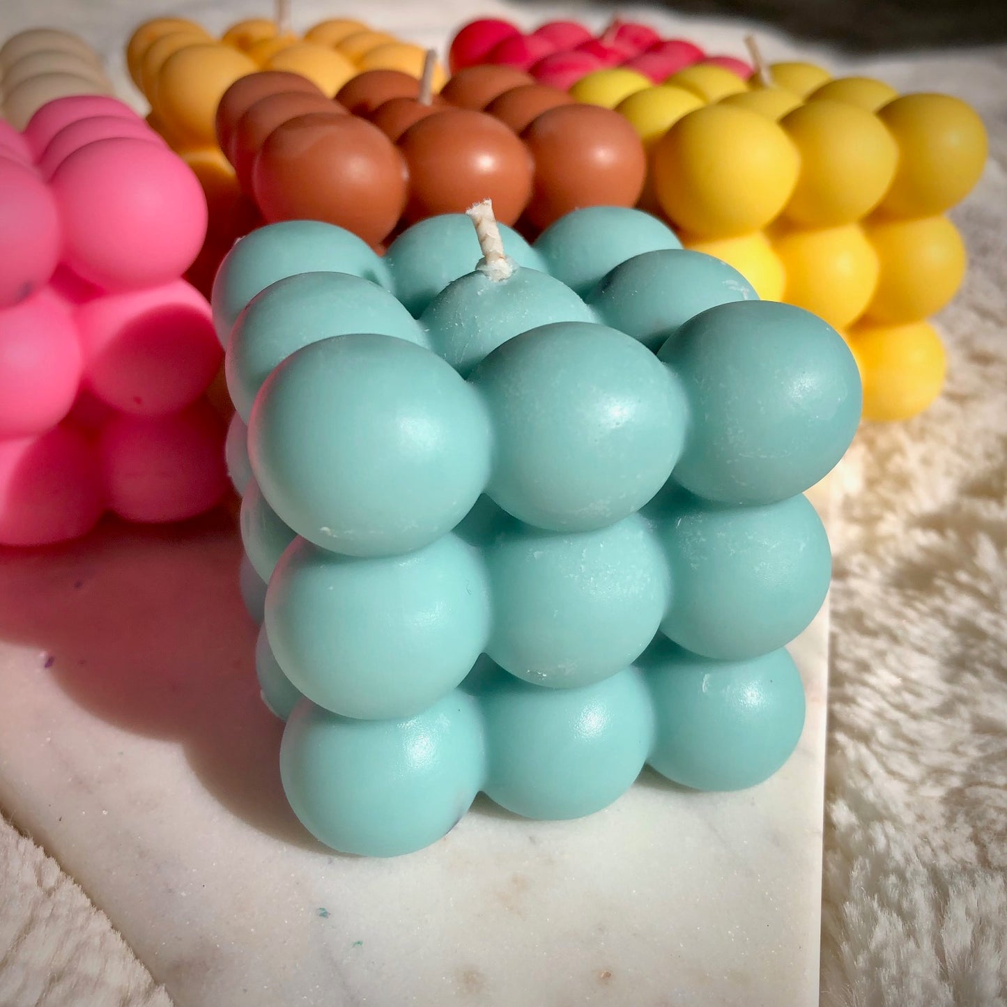 Blue bubble candle on marble 