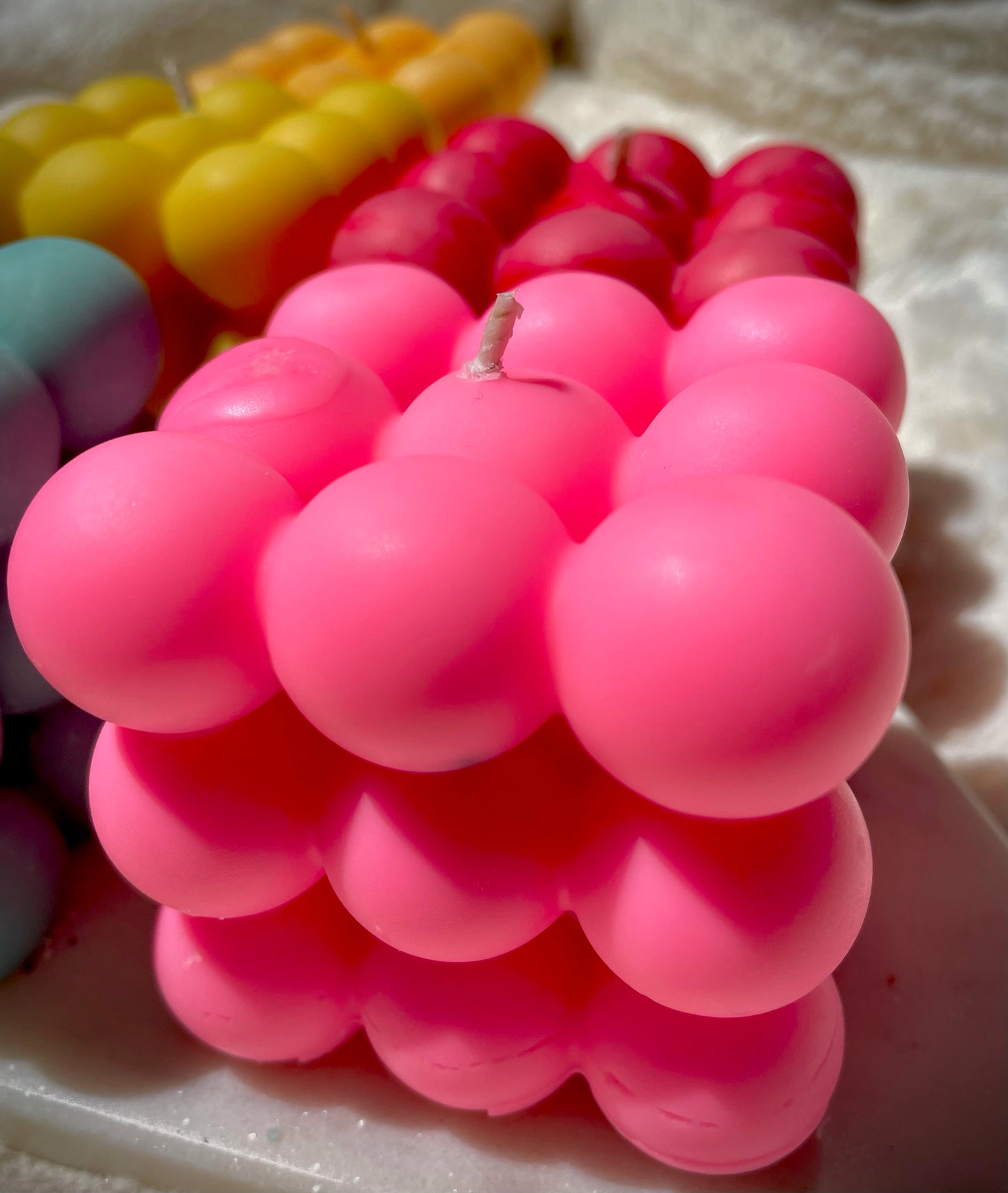 Pink bubble candle on marble 