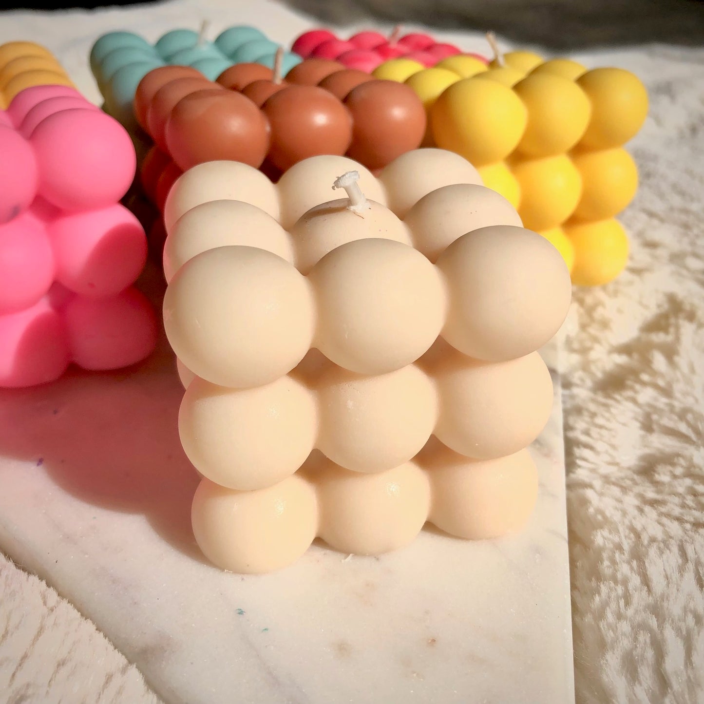 Cream bubble candle on marble 