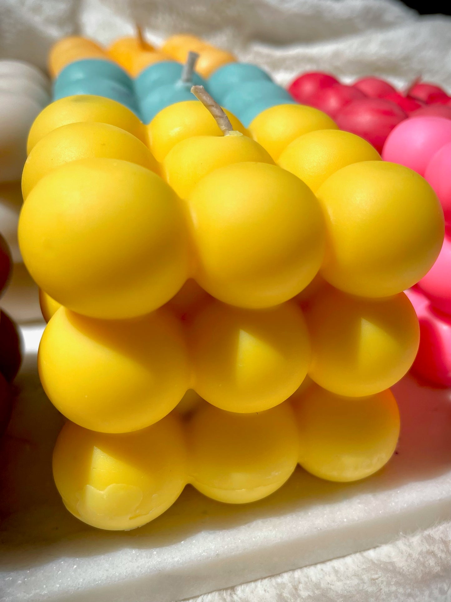 Yellow bubble candle on marble 