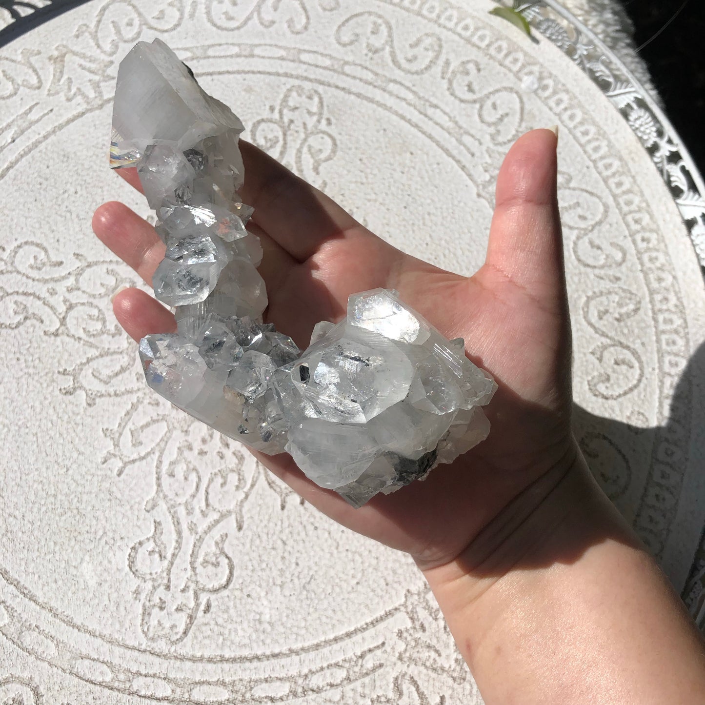 Clear apophyllite in shape of phallus in hand